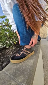 Zapatillas Dallas de cuero blanco, con detalles en gamuza beige y tiras laterales rosadas, suela de goma y diseño urbano.