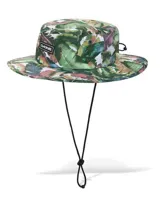 Sombrero Dakine No Zone Hat con estampado tropical de hojas de palmera en tonos verdes y marrones, ala ancha y cordón ajustable negro para la barbilla.