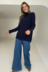 Polera de tejido de punto color azul, con cuello alto, mangas largas y tajos laterales en el ruedo.