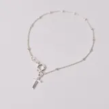Pulsera tipo denario confeccionada en plata 925, compuesta por una cadena fina con pequeñas esferas intercaladas y un dije colgante en forma de cruz.