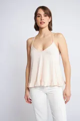 Musculosa de breteles finos con diseño de espalda nadadora y detalle de volados en el ruedo.