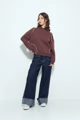 Canguro negro de silueta amplia con capucha integrada y detalles de líneas blancas que recorren el frente y las mangas.