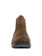 Botín estilo Chelsea color marrón oscuro, confeccionado en cuero con paneles laterales elásticos. Presenta una suela robusta de goma y EVA con tecnología de absorción de impactos y una presilla trasera con detalle de bandera.