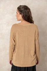 Buzo de punto ligero con acabado metalizado, color beige dorado, con escote en V, mangas largas y corte relajado.