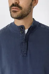 Sweater marrón con cuello mao abotonado y detalle de tejido en los hombros.