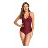 Malla entera de color verde oscuro, combinada con un diseño floreado en la parte inferior. Presenta escote halter cruzado y fruncidos en la zona del abdomen.