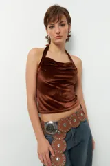 Top negro de terciopelo con escote halter, sin mangas y espalda descubierta.