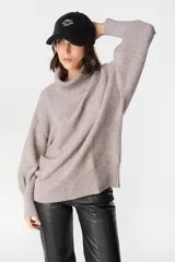 Gorro tipo baseball de tela tipo peluche color crudo, con bordado central en color marrón.