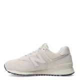 Championes urbanos New Balance modelo 574, color marfil, confeccionados en gamuza y malla con detalles texturizados en la puntera. Presentan el logo N característico en los laterales y suela con diseño moteado.