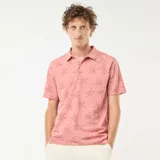 Remera polo rosada de piqué con estampado de palmeras.