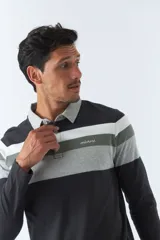 Remera polo de manga larga con diseño a rayas horizontales en tonos negro, gris y blanco. Logo de la marca Mistral bordado en el pecho.