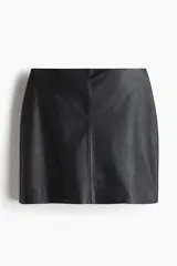 Pollera mini negra de tiro alto con acabado de efecto cuero. Presenta un corte recto y costura central en la espalda, con pinzas para estilizar la figura. La prenda está forrada.