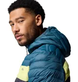 Campera tipo puffer con capucha de la marca Columbia, modelo Powder Pass. Presenta un diseño de bloques de color en tonos azul, gris y amarillo, con cierre frontal completo y bolsillos laterales. Es una prenda ligera y abrigada, ideal para actividades al aire libre.