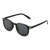 Lentes de sol Valizas con armazón redondo de policarbonato negro y cristales oscuros, con detalles metálicos dorados en las esquinas superiores y extremos de las patillas.