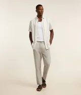 Pantalón masculino relaxed fit confeccionado en oxford de algodón, color beige, con trabillas en la cintura y cordón ajustable con lazo. Cuenta con bolsillos delanteros y traseros.