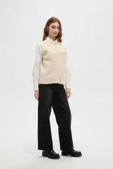 Chaleco de punto texturizado en color marrón chocolate, con cuello redondo y cierre frontal de botones a tono.