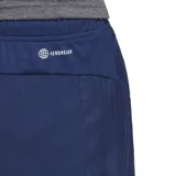 Short de entrenamiento Adidas, color azul marino, confeccionado en tejido liso de poliéster reciclado con tecnología AEROREADY. Presenta cintura elástica con cordón interior y bolsillos delanteros con cierre. En la parte inferior delantera derecha lleva el logo de tres barras de Adidas en color blanco.