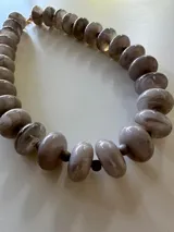 Collar de cuentas grandes de resina en tonos verde militar con efecto jaspeado.