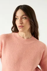 Sweater lila de punto suave con cuello redondo y hombros caídos.