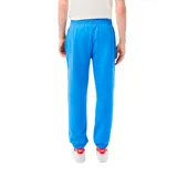Pantalón de jogging azul con cintura elástica y cordón ajustable. Estampado lateral con logo de Lacoste y diseño de Netflix.