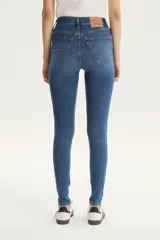 Jeans de tiro alto color azul, ajustados en cadera y muslos, con pierna súper ajustada y denim stretch.