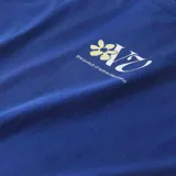 Remera azul de manga corta con estampado de flores y logo de la marca en el pecho.