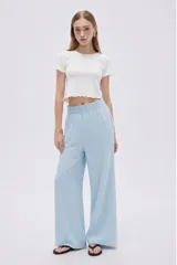 Pantalón celeste de lyocell, de corte ancho y tiro alto, con bolsillos laterales.