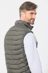 Chaleco capitoneado de color verde militar, con cierre frontal y capucha desmontable. Presenta un diseño acolchado con costuras horizontales y logo bordado en el pecho.