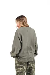 Crewneck de rústico piqué color verde militar con estampado en el frente y la espalda. Mangas ranglan.