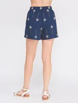 Short azul marino de tiro alto con bordado tropical de palmeras en tono beige, bolsillos laterales y cintura elastizada.