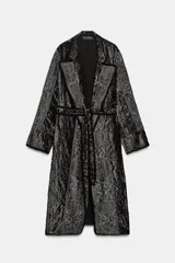 Kimono largo de terciopelo con cuello solapa, manga larga y cinturón ajustable del mismo tejido. Presenta bordados con hilo metalizado, bolsillos laterales ocultos y acabados desflecados.