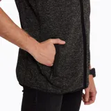 Chaleco de polar gris jaspeado con cierre frontal, bolsillo en el pecho con cierre y bolsillos laterales con cierre e interior de polar.