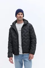 Campera de nylon matelaseada con capucha integrada, cierre frontal y diseño de costuras geométricas. Presenta un ajuste regular y es ideal para climas fríos.