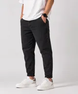 Pantalón de jean slouchy para hombre, color negro con efecto gastado, corte relajado y botamangas con vuelta.