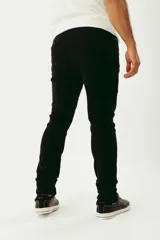 Pantalón de pana color gris topo, corte regular, con cinco bolsillos, cierre con botón y logo bordado.