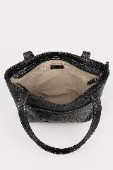 Cartera tipo tote de cuero vacuno marrón, con doble asa larga de hombro y cierre superior. Presenta un bolsillo frontal externo con textura símil cocodrilo y detalles de costuras visibles.