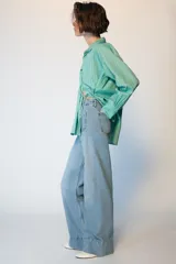 Jeans de tiro alto con corte wide leg y pernera ancha. Presenta bolsillos de plastrón en el delantero y cierre frontal con cremallera y botón.