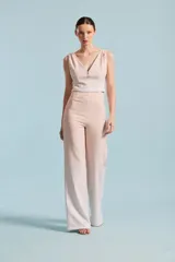 Top corto color verde menta, sin mangas, con escote en V y tres botones decorativos brillantes en el centro del pecho.