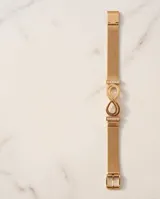Pulsera de acero con baño de oro, con diseño de símbolo de infinito y barras con circonias en los laterales, tipo malla milanesa.