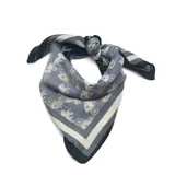 Pañuelo cuadrado de tela liviana, con estampado de carruajes antiguos en tonos gris y crema, y bordes en contraste negro.