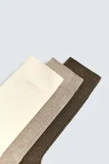 Pack de tres pares de calcetines de vestir, confeccionados en tejido acanalado (rib) con mezcla de algodón. Los colores son crema, beige/topo y marrón oscuro.