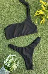 Conjunto de bikini negro con corpiño de un hombro y bombacha colaless.