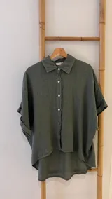 Camisa verde militar de lino italiana con botones de nácar, corte holgado, cuello camisero y mangas cortas con dobladillo.
