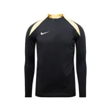 Camiseta de entrenamiento Nike Strike negra con detalles dorados en cuello y hombros, cierre parcial con cremallera y logo de la marca bordado en el pecho.