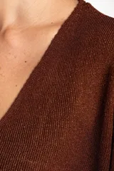 Sweater de punto con acabado brillante, cuello en V y mangas tres cuartos. Presenta un diseño holgado y tejido traslúcido.