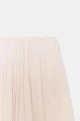 Falda midi color beige claro, con cintura elástica y bajo abullonado con elástico interior.