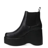 Botas negras de cuero sintético con plataforma y elástico en los laterales.