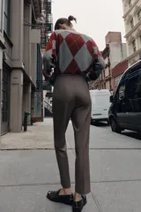 Pantalón tobillero de tiro alto con diseño de cuadros, costuras marcadas en el delantero y espalda, bolsillos laterales de vivo y cierre frontal con cremallera, botón interior y gancho metálico.
