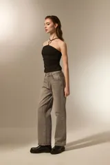 Top negro al cuerpo con diseño halter, confeccionado en poliéster. Presenta un detalle de aro metálico en el centro del escote y breteles finos.