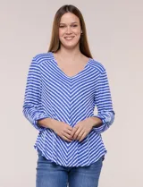 Remera de calce relajado y silueta fluida, con escote en V y mangas tres cuartos con presilla y botón. Diseño de rayas dispuestas en ángulo tipo espiga en el delantero y ruedo redondeado.